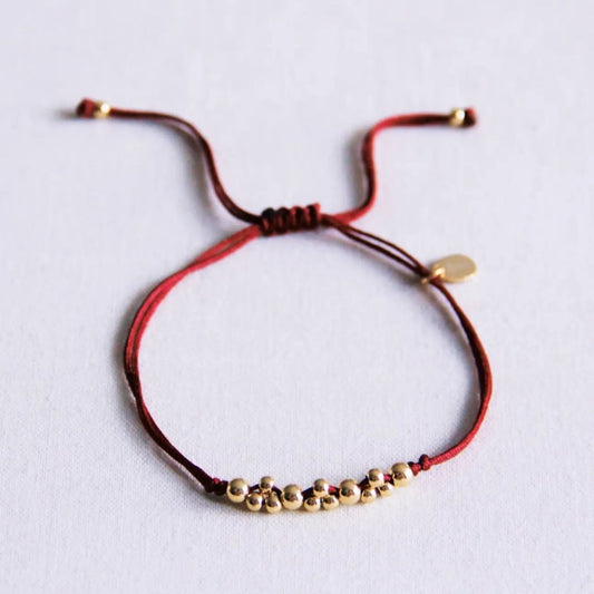 Satinarmband mit goldfarbenen Perlen bordeaux/gold