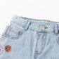 Jeansshorts mit Blumenstickerei