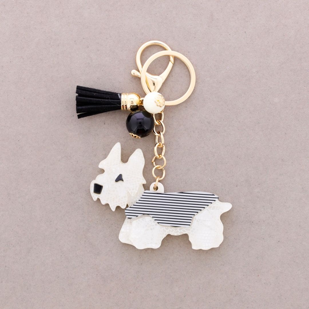 Schlüsselanhänger aus Kunstharz 'Welpe' weiß/schwarz