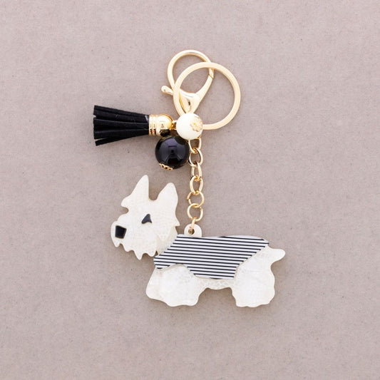 Schlüsselanhänger aus Kunstharz 'Welpe' weiß/schwarz