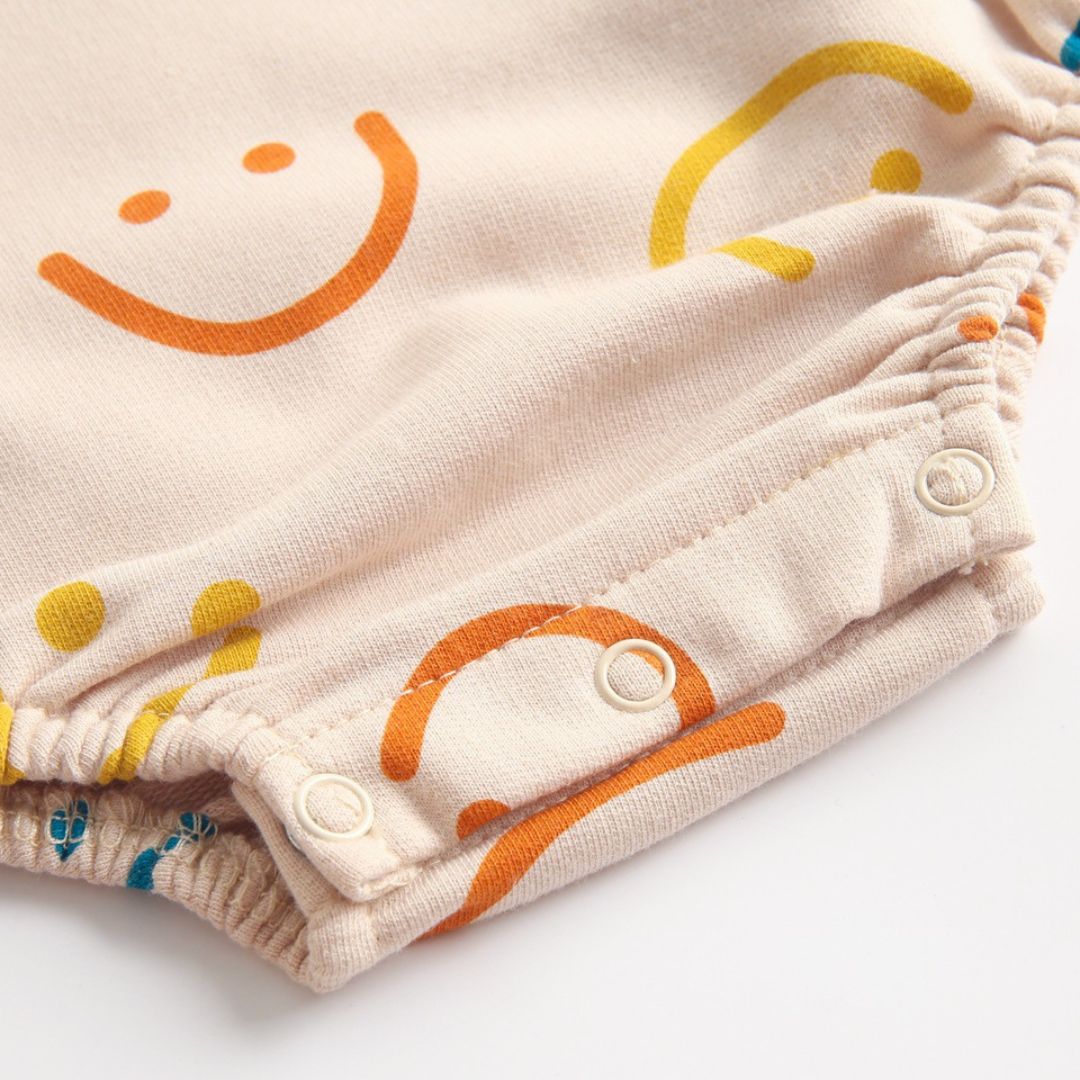 Overall Strampler beige mit lustigen Smileys